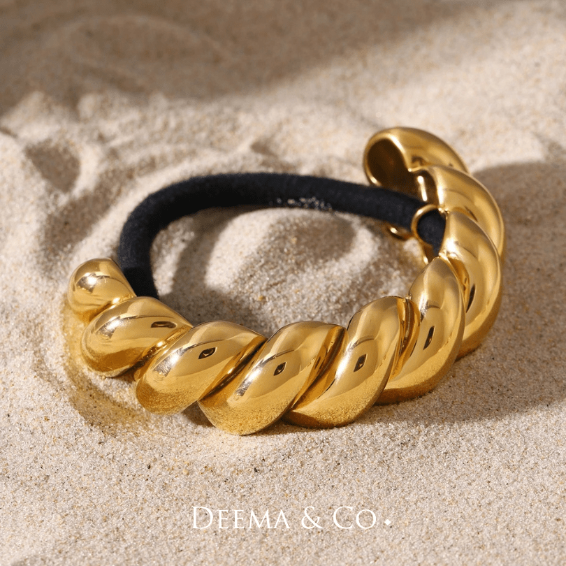 sadira croissant twirl hair tie gold flatlay